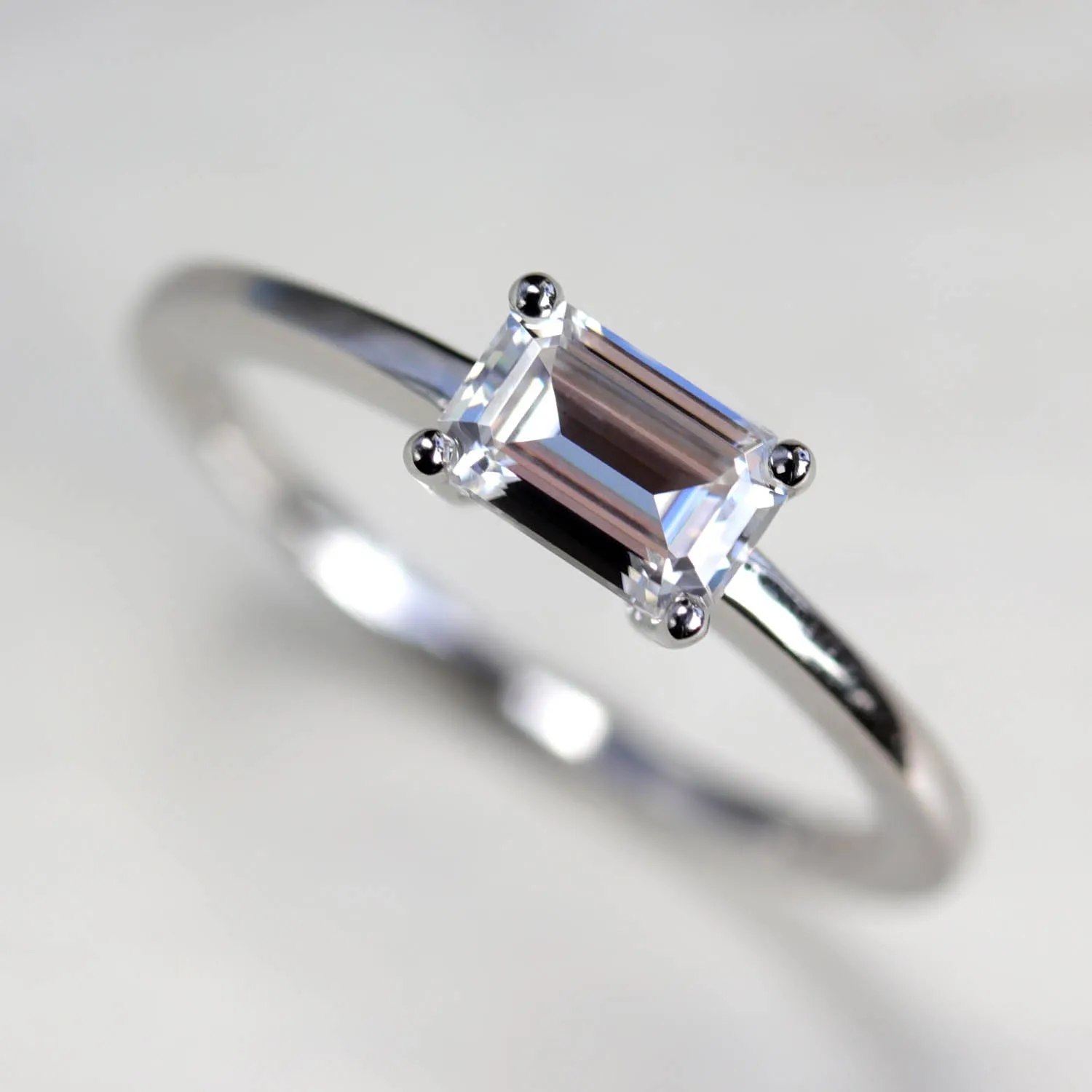 Emerald Cut East-West Basket Solitaire Engagement Ring