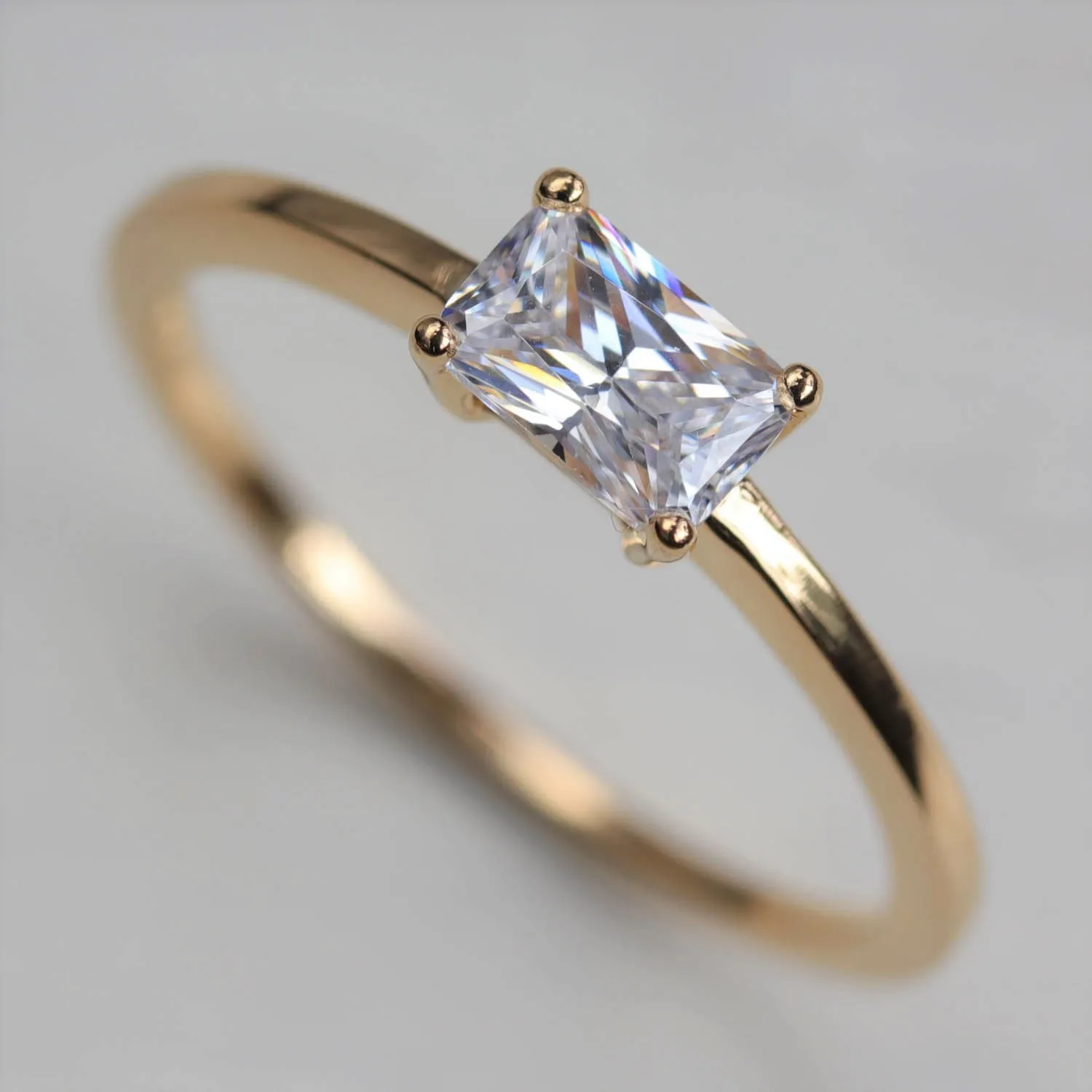 Emerald Cut East-West Basket Solitaire Engagement Ring