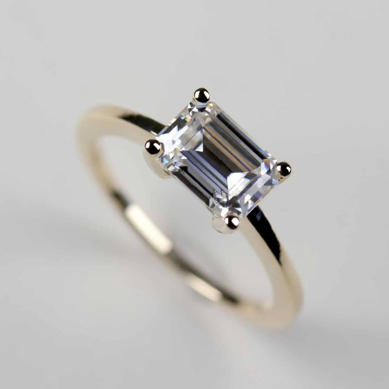 Emerald Cut East-West Basket Solitaire Engagement Ring